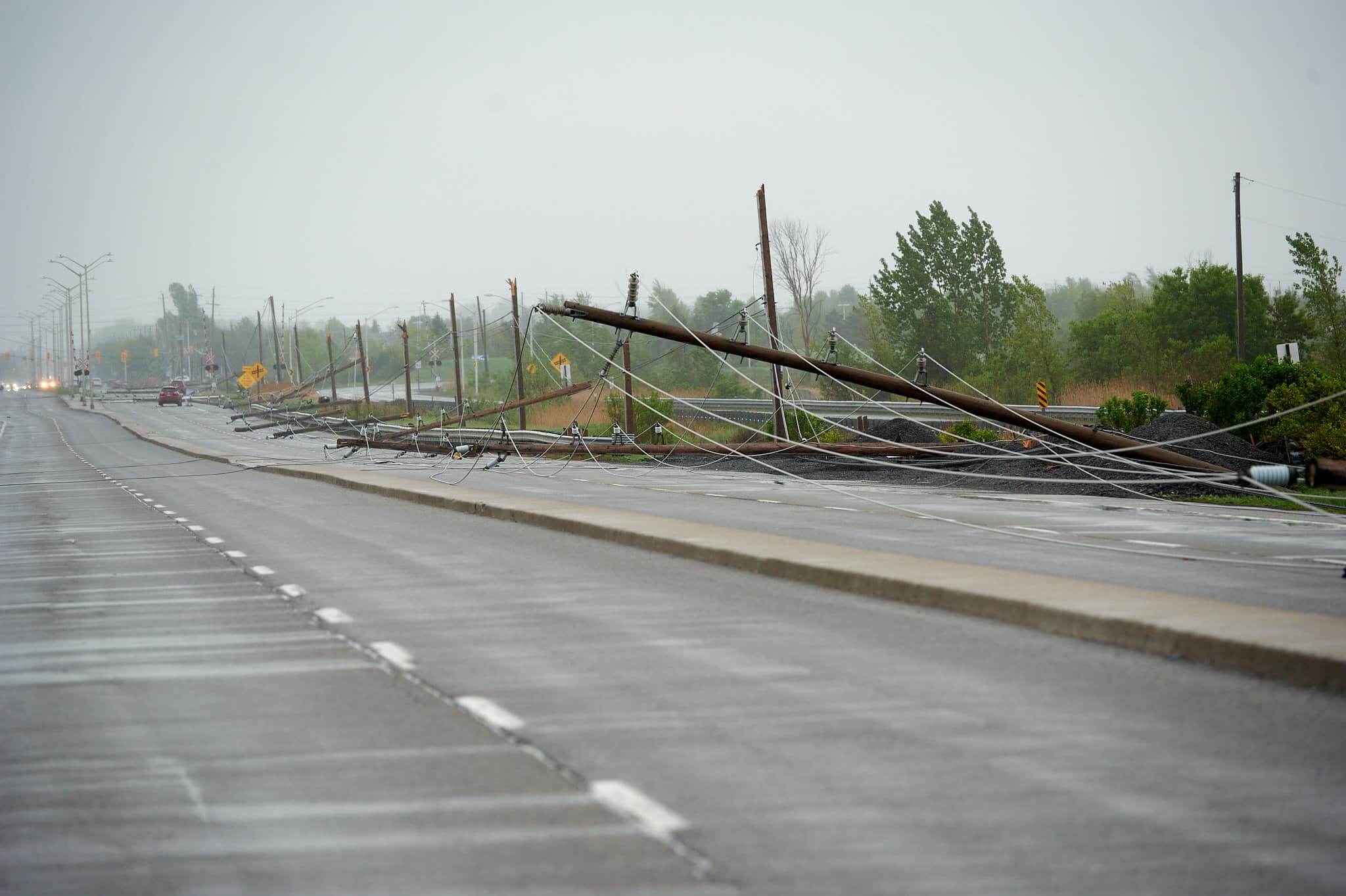 Image of downed power poles on a street.