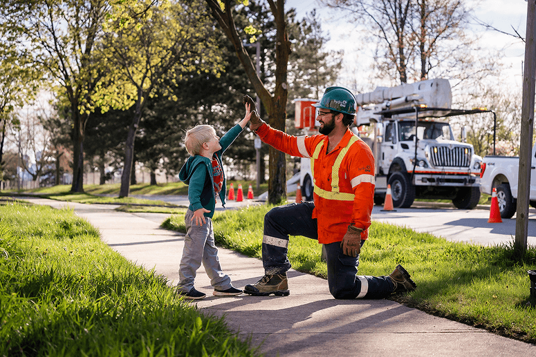 Hydro One employees interacting with a family