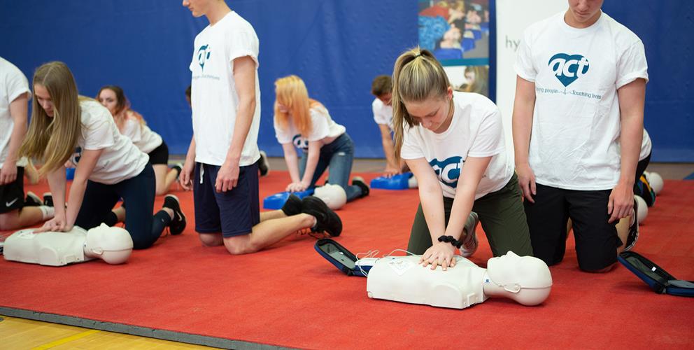 Photo of teens doing CPR training through the ACT Foundation