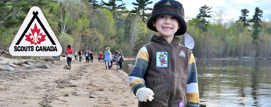 a boy on the beach in his scouts uniform
