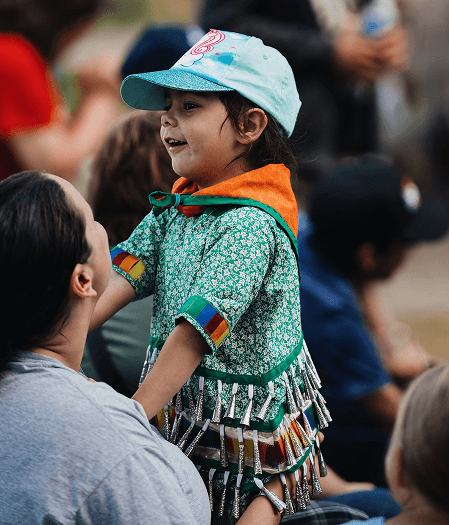 Young community member participating in a cultural gathering supported through Hydro One Indigenous partnerships