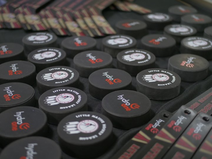 photo of Hydro One-branded hockey pucks and mini-sticks