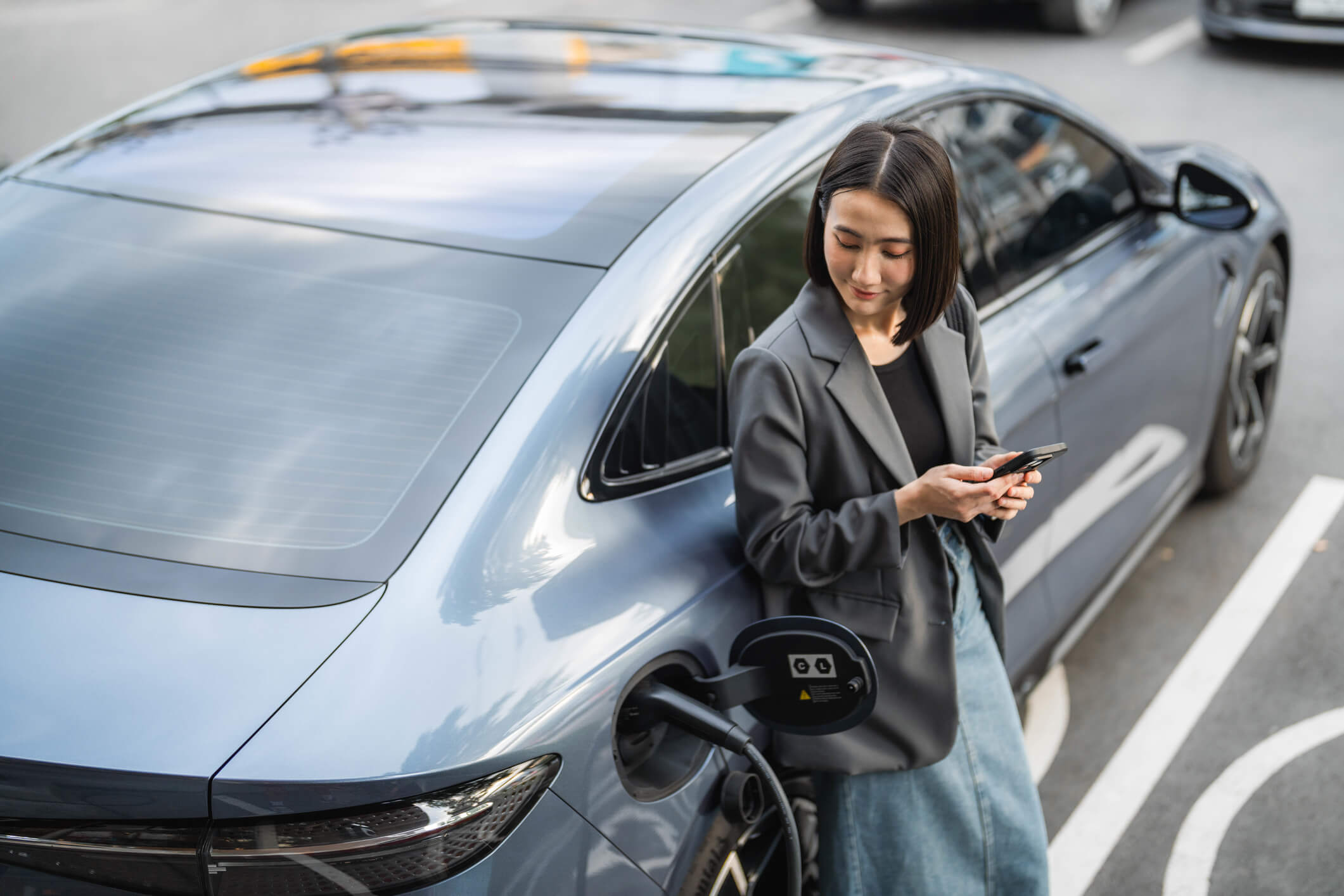 Woman in business park charging EV