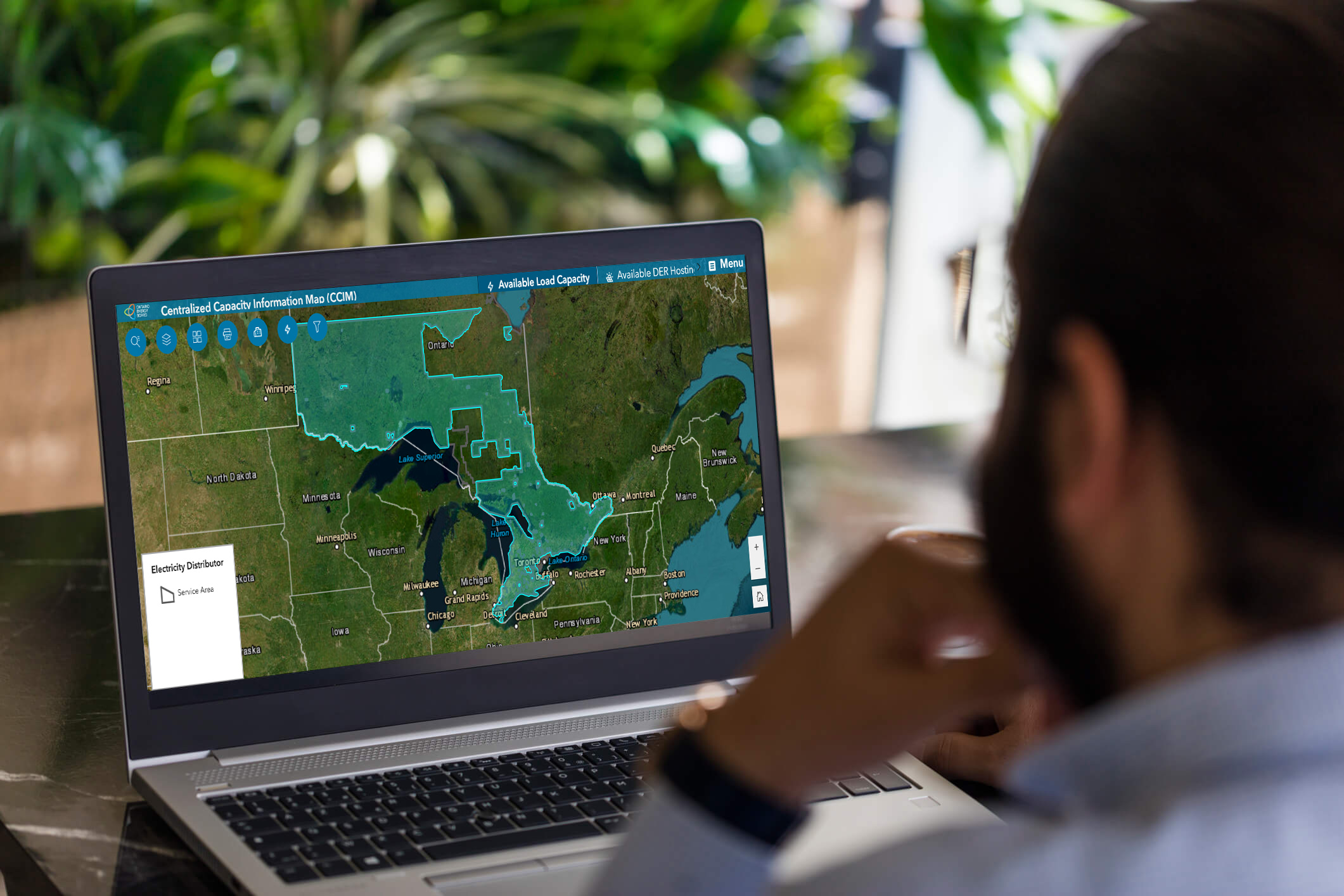Photo of man using the OEB's Centralized Capacity Information Map on a laptop