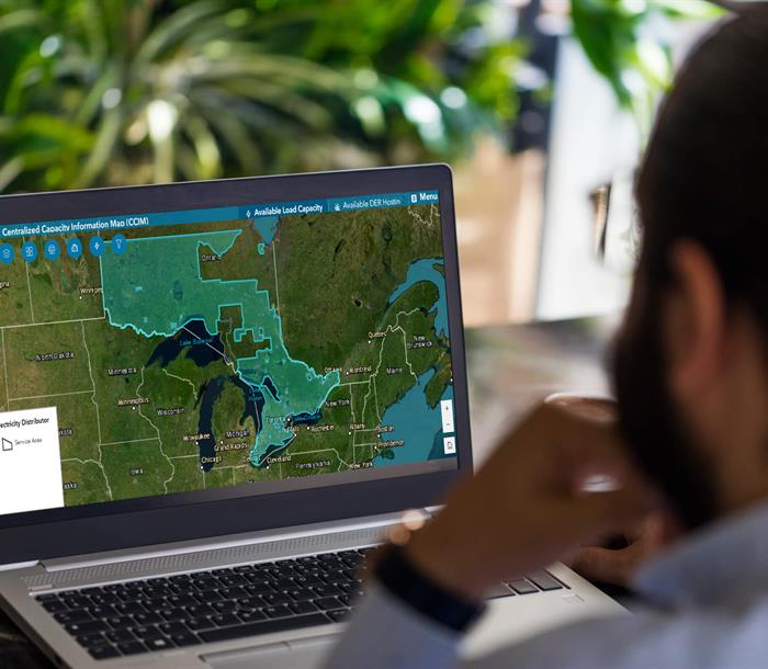 photo of a man using the OEB's Centralized Capacity Information Map on a laptop