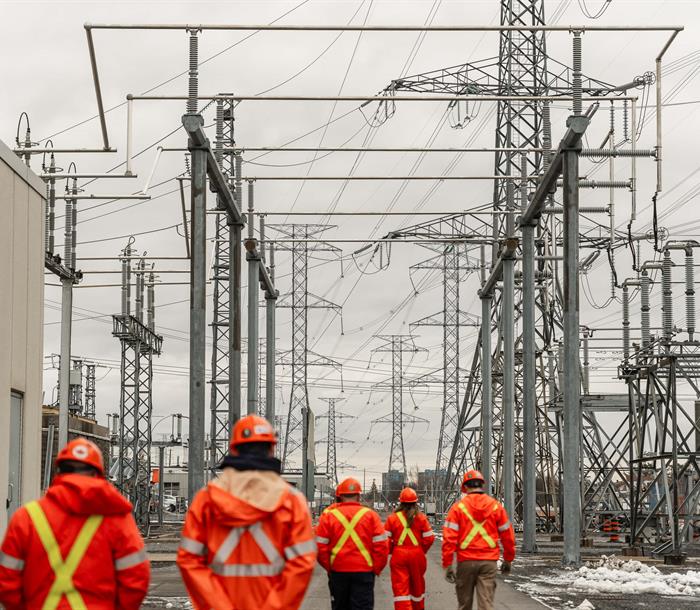 photo of Hydro One workers touring a large transformer station