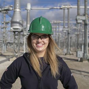 Photo of a Hydro One employee in front of a transformer station