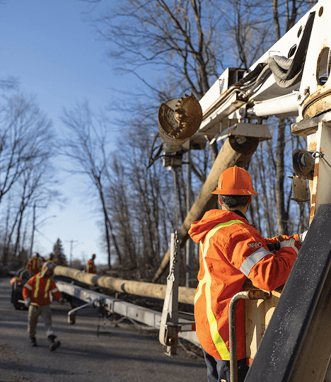 Construction worker lifting wooden logs