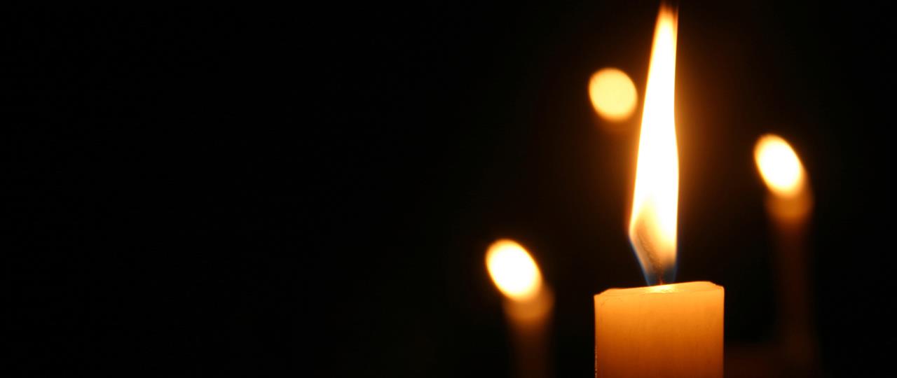 Photo of a lit memorial candle