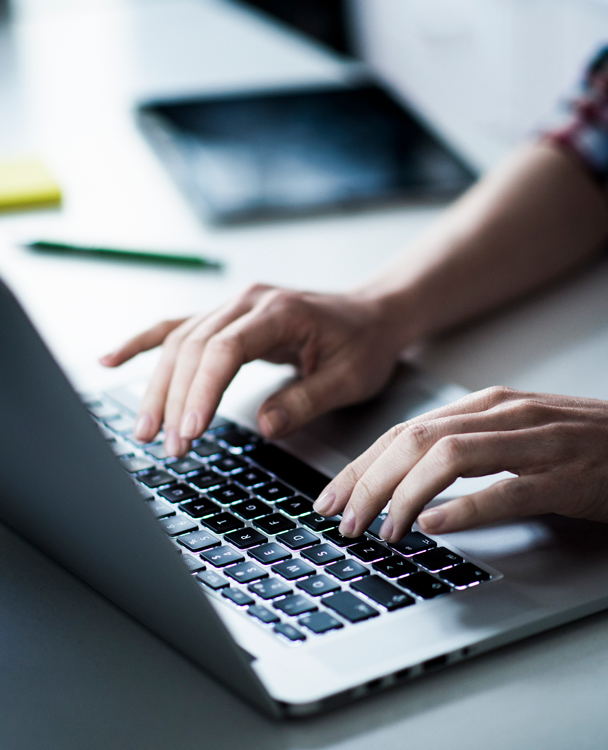 Hands on a laptop keyboard