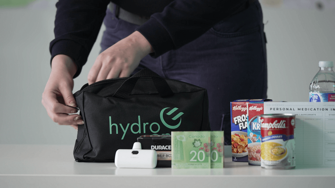 Image of Hydro One Employee unpacking an emergency preparedness kit