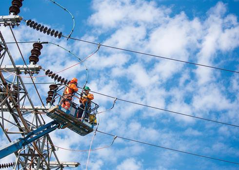 photo of Hydro One workers on a transmission tower