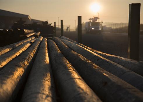 photo of a stack of wooden distribution poles