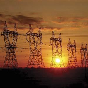 image of transmission towers at sunset