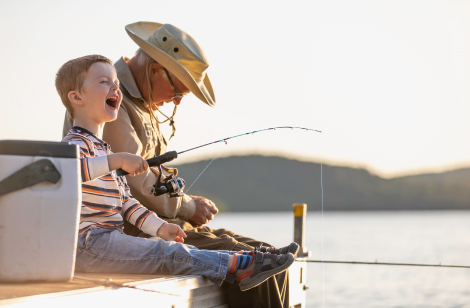 Grandpa and son sitting on dock