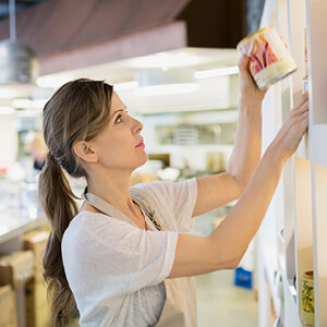 Image of a woman in a store stocking a shelf