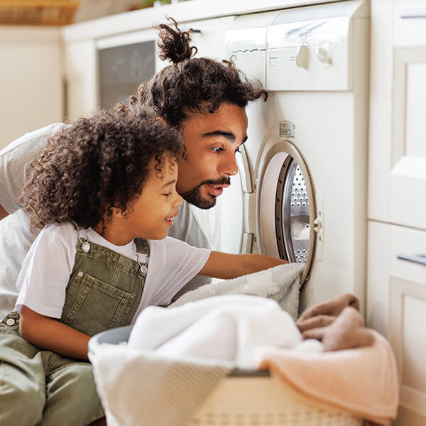 Person using a washing machine at home