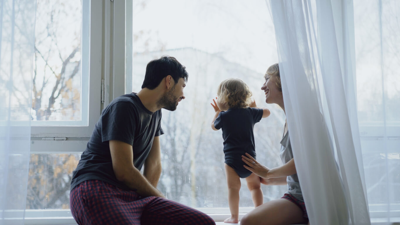 Family looking out at snowy landscape.