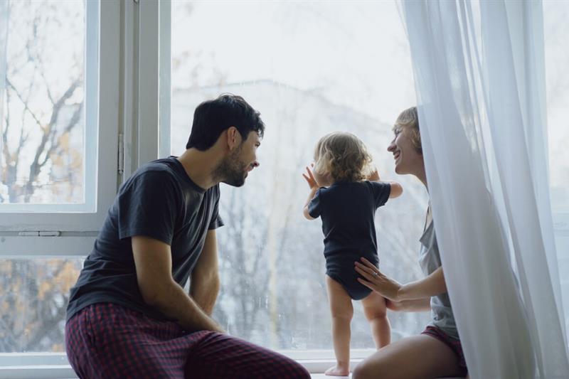 Family staring out the window on a winter day