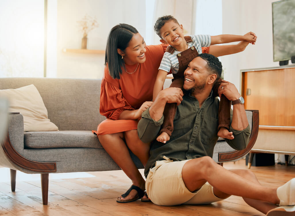 Family sitting on floor together smiling