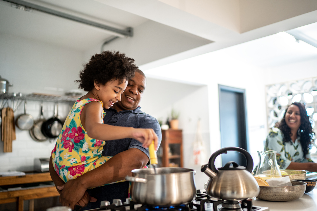 Father and daughter cooking together.