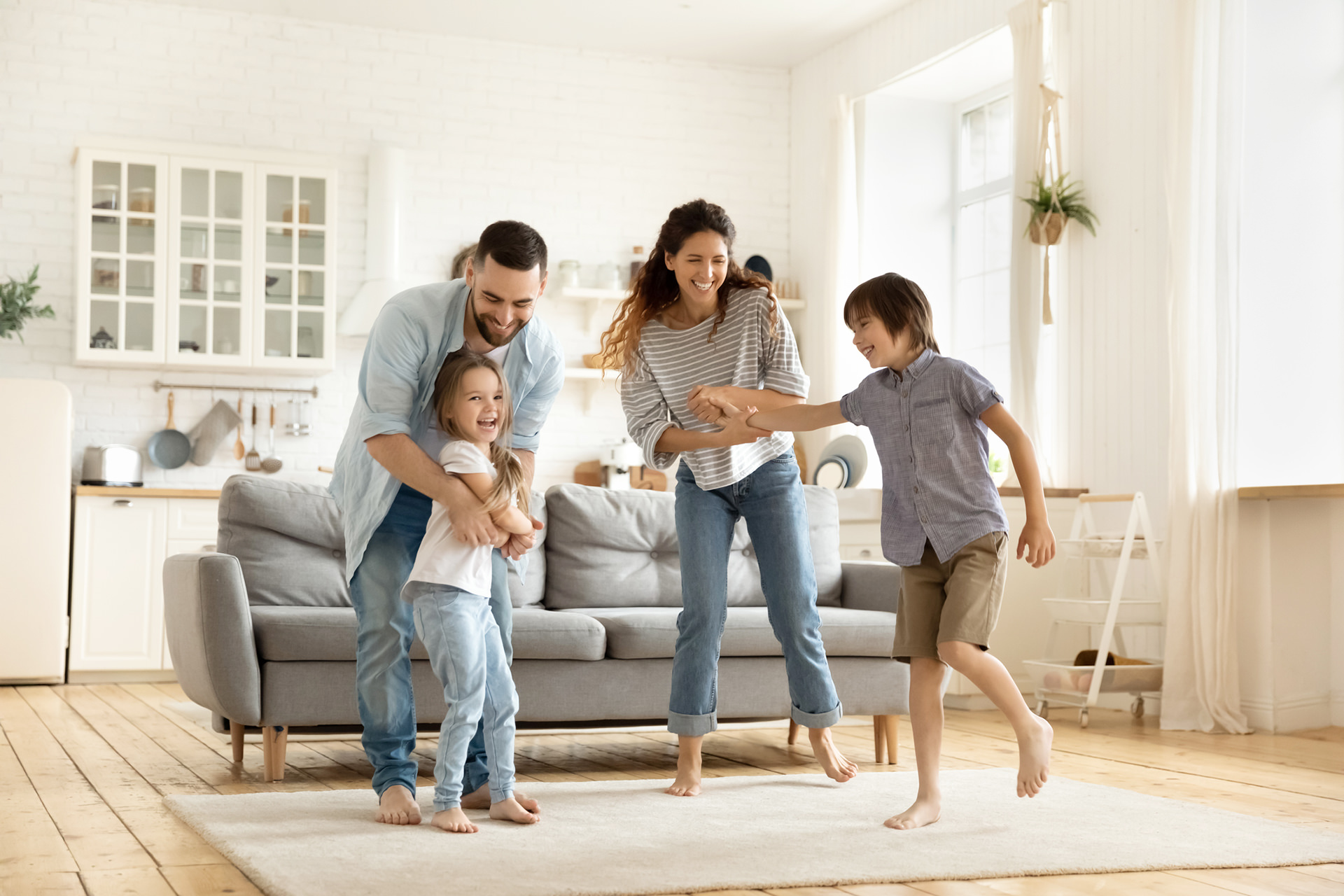 Family laughing and hanging out in their living room