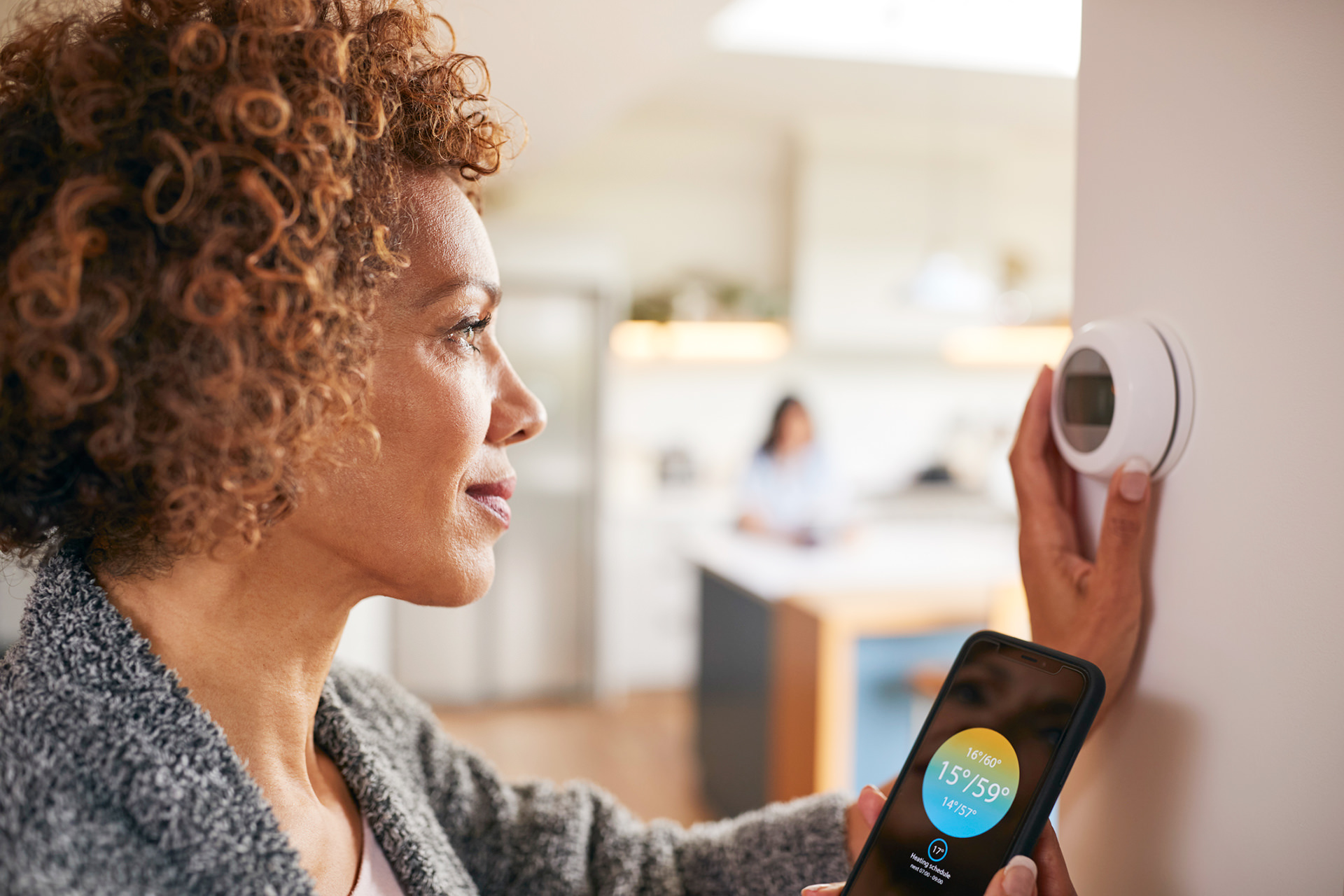 Woman using a thermostat