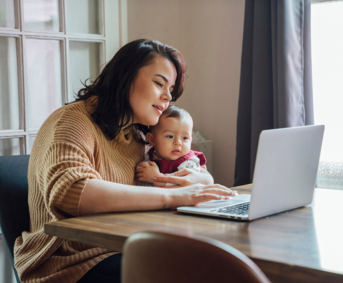 Mother with baby looking at a laptop