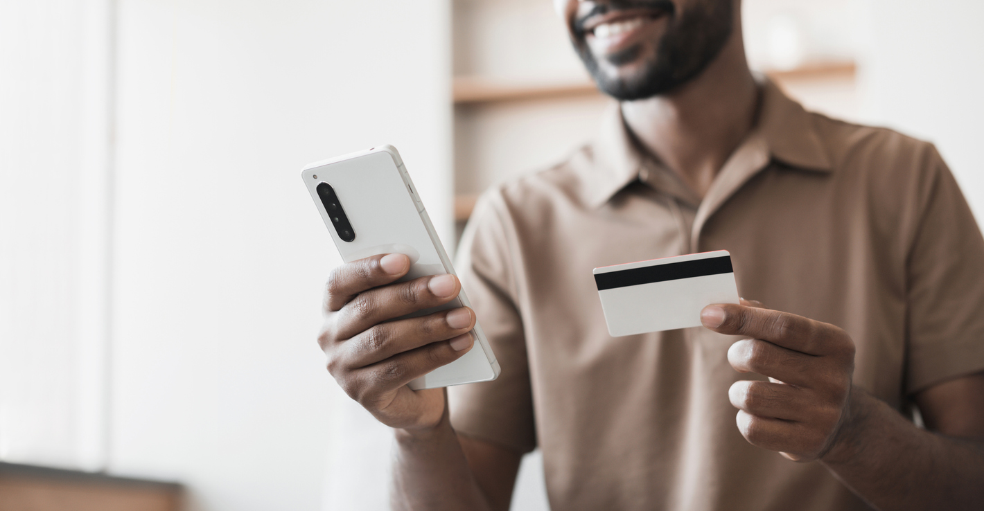 Man about to pay via credit card on smartphone