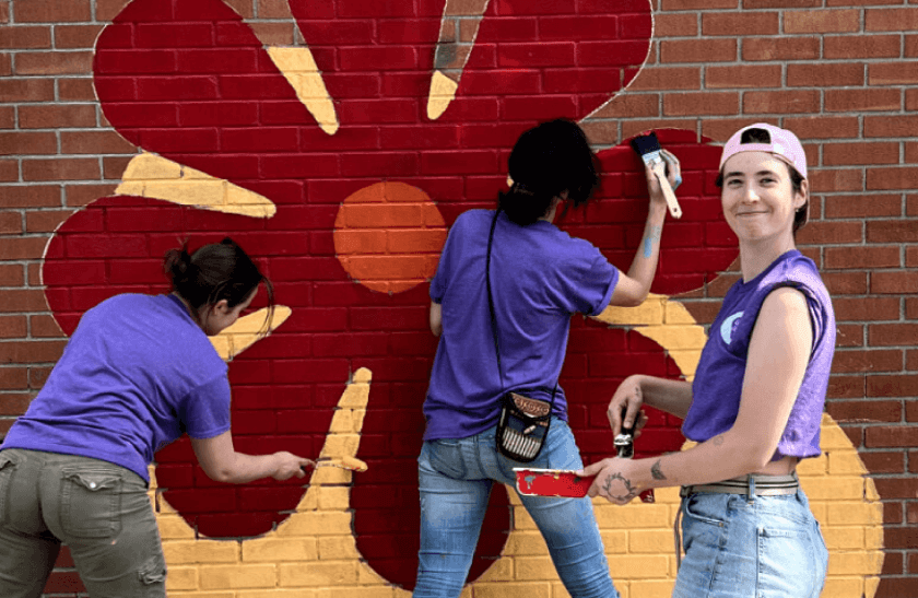 photo of volunteers in Sudbury painting a mural