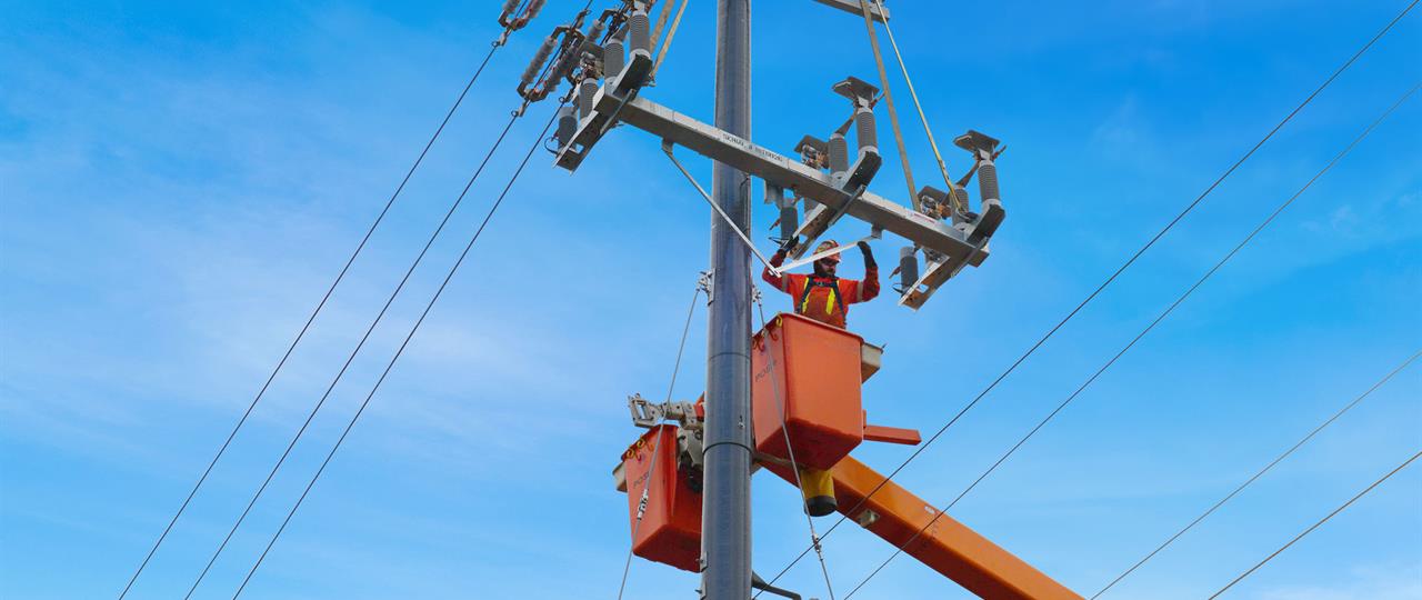 Man working on reparing electrical lines in a bucket truck