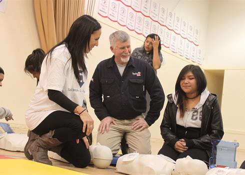Hydro One employee teaching CPR to high school students