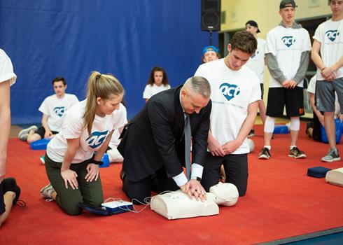 Jason Fitzsimmons doing CPR training with the ACT Foundation in a high school