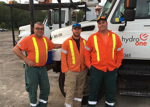 Forestry crew in front of a Hydro One truck who saved the life of an elderly woman hit by a car