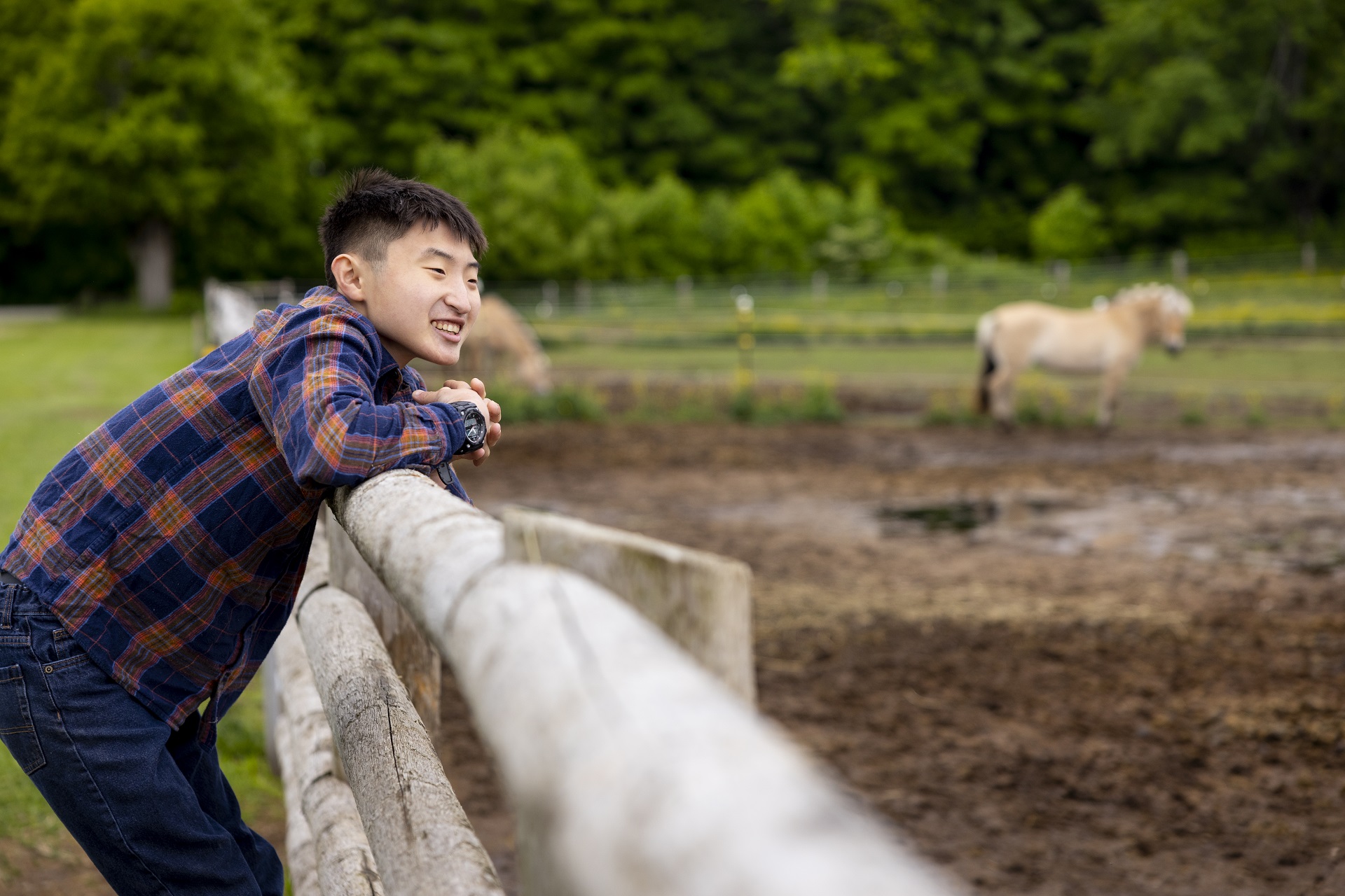 Aidan looks at horses while volunteering with the Saddle Up For Success program at Hope Haven Therapeutic Riding and Wellness Centre in Markdale, Ontario, Canada on Thursday, June 9, 2022. Hydro One has provided Hope Haven Therapeutic Riding and Wellnes
