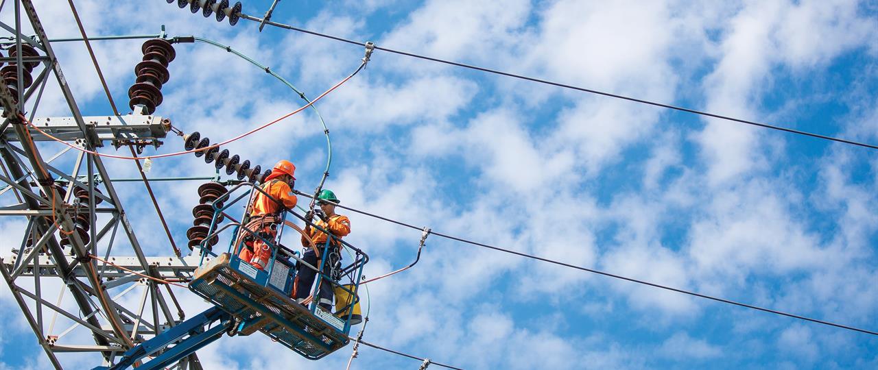 Photo of Hydro One linemen working on a transmission tower